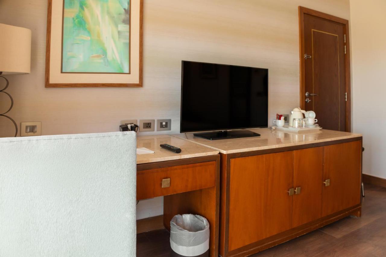 Sharm Dreams Vacation Club - Aqua Park Hotel Bagian luar foto A television in a hotel room